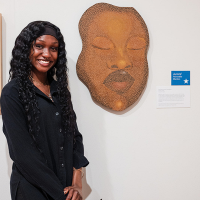 Woman standing by artwork